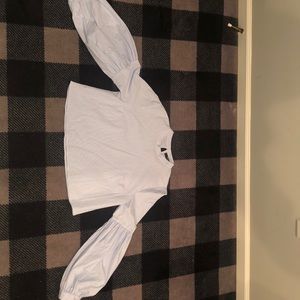 A cropped top with puffy arm sleeves.